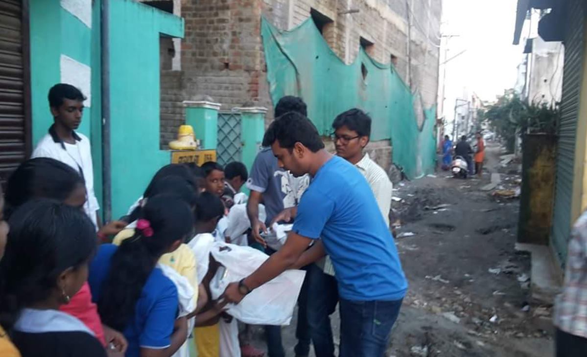 MD distributing groceries during 2015 Chennai floods relief